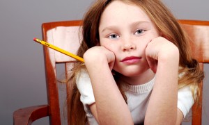 Young Girl Looking Bored Holding Pencil